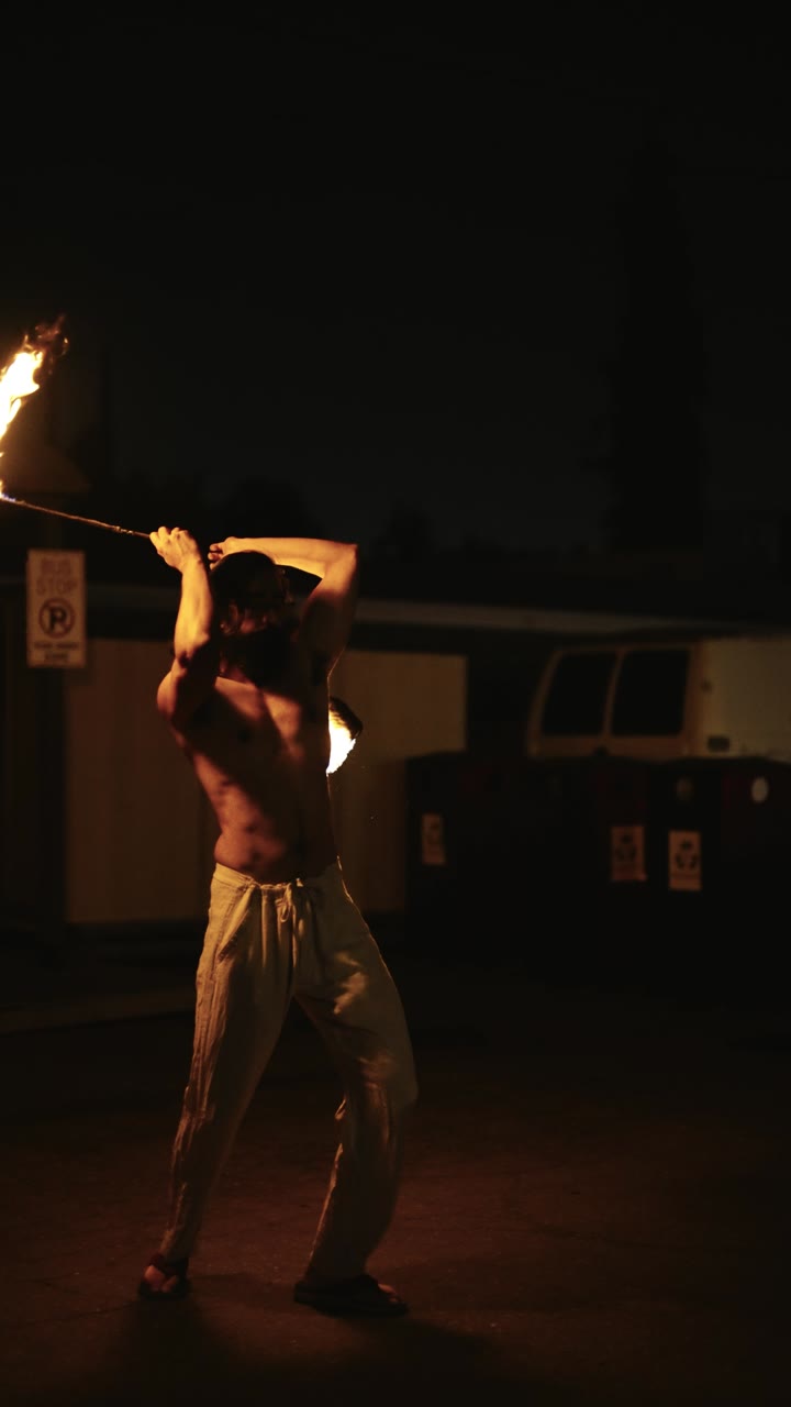 Poi spinner with two lit heads streaking overhead